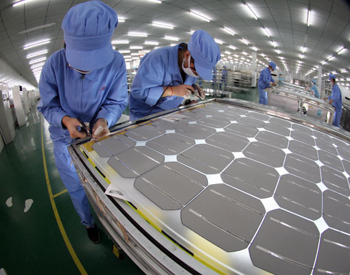 Workers produce solar-cell modules in a factory in China’s Jiangsu Province.